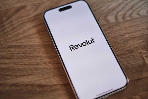 A cell phone sitting on top of a wooden table
