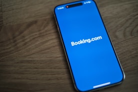 A blue samsung phone with the logo of bookking com on it