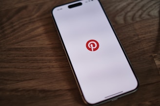 A cell phone with a pin on the screen