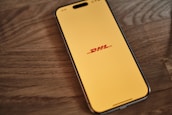 A cell phone sitting on top of a wooden table