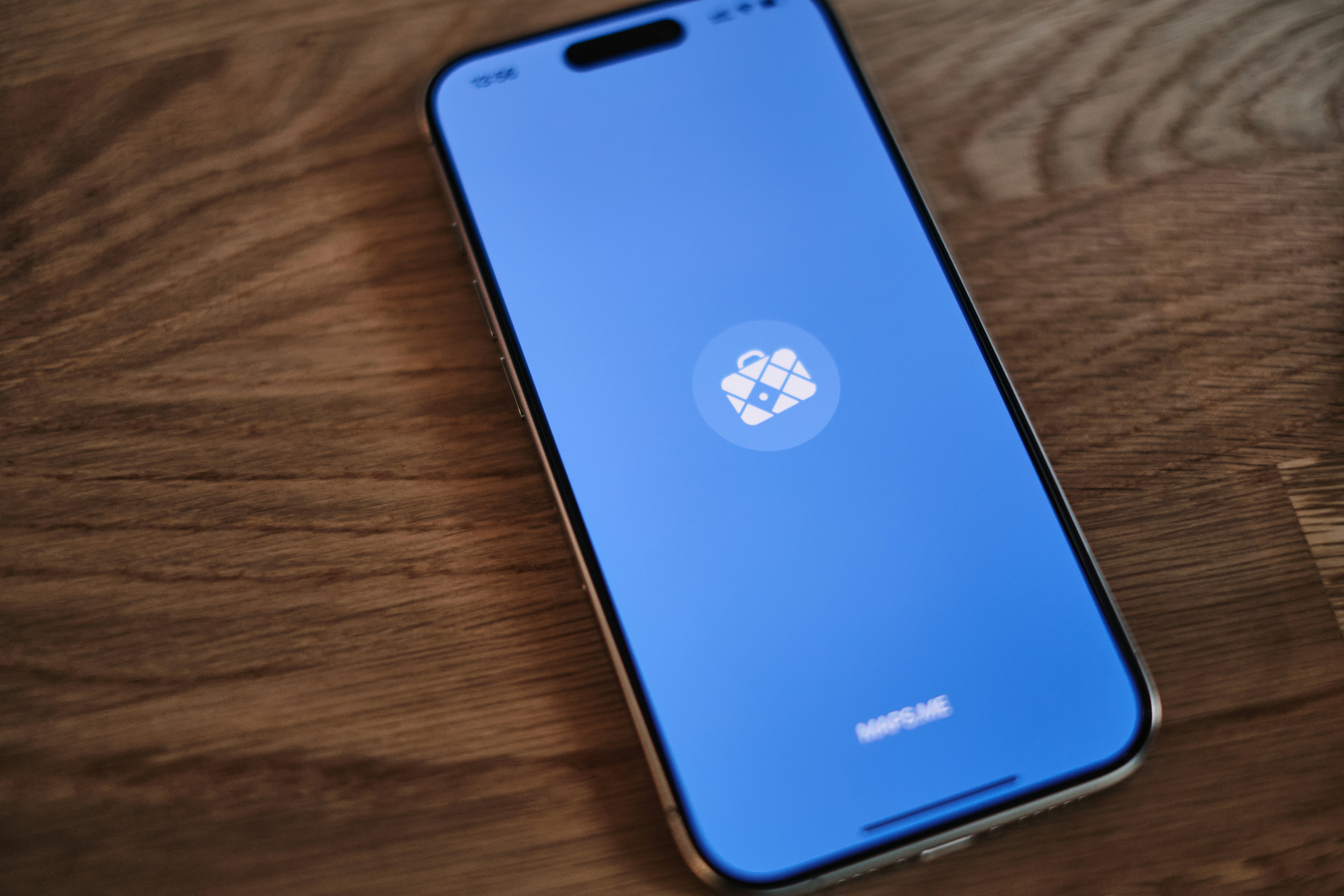 A cell phone sitting on top of a wooden table