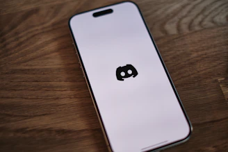 A cell phone sitting on top of a wooden table