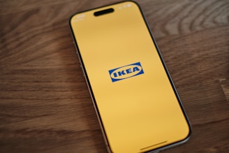 A cell phone sitting on top of a wooden table