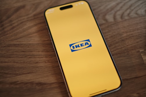 A cell phone sitting on top of a wooden table