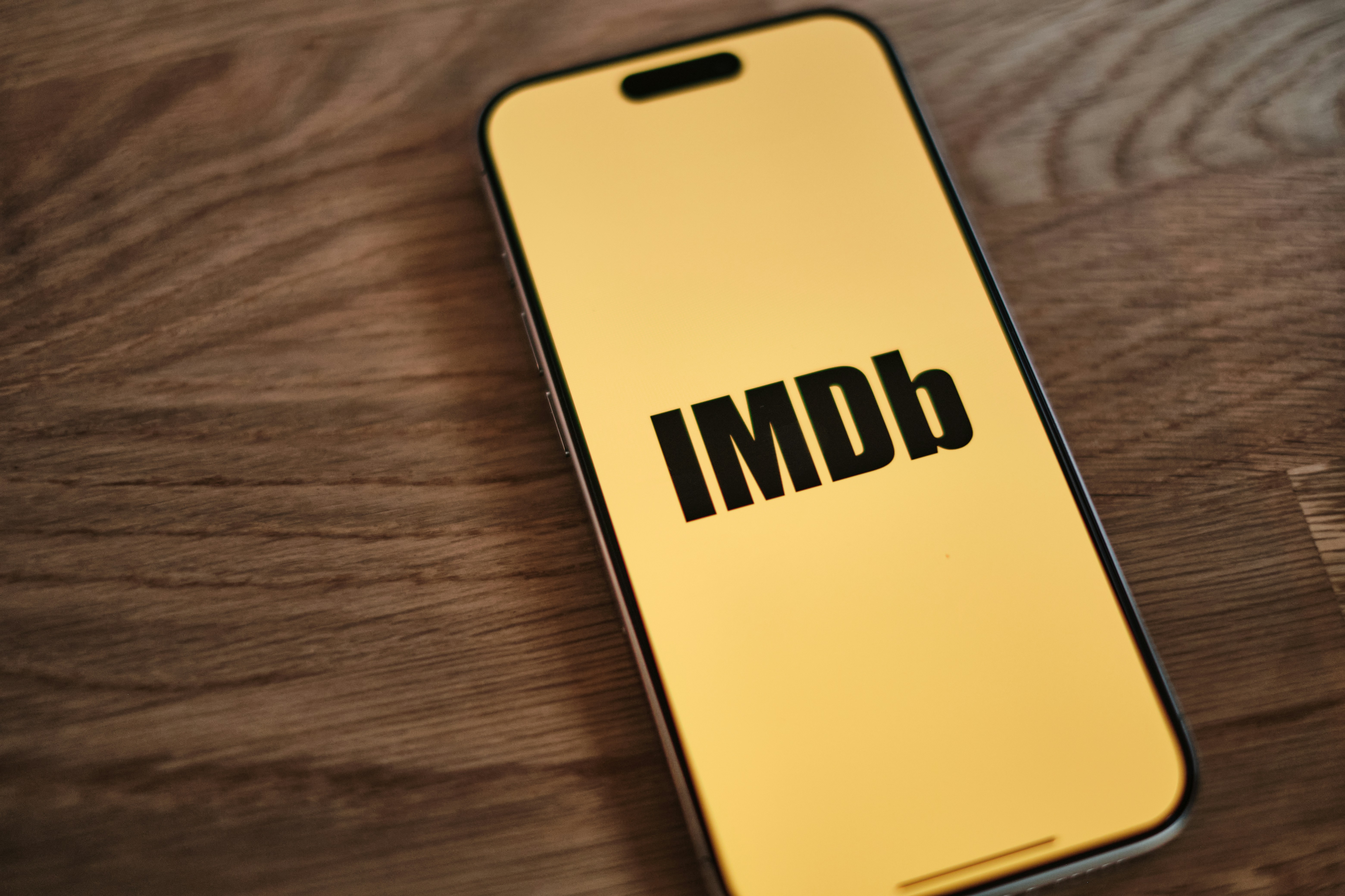 A yellow iPhone with the word imdb on it