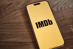 A yellow iPhone with the word imdb on it