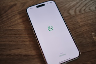 A white phone with a green message bubble on it