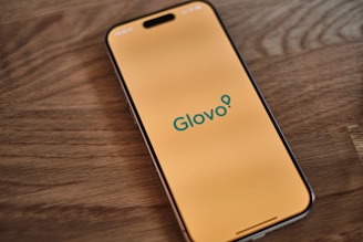 A cell phone sitting on top of a wooden table