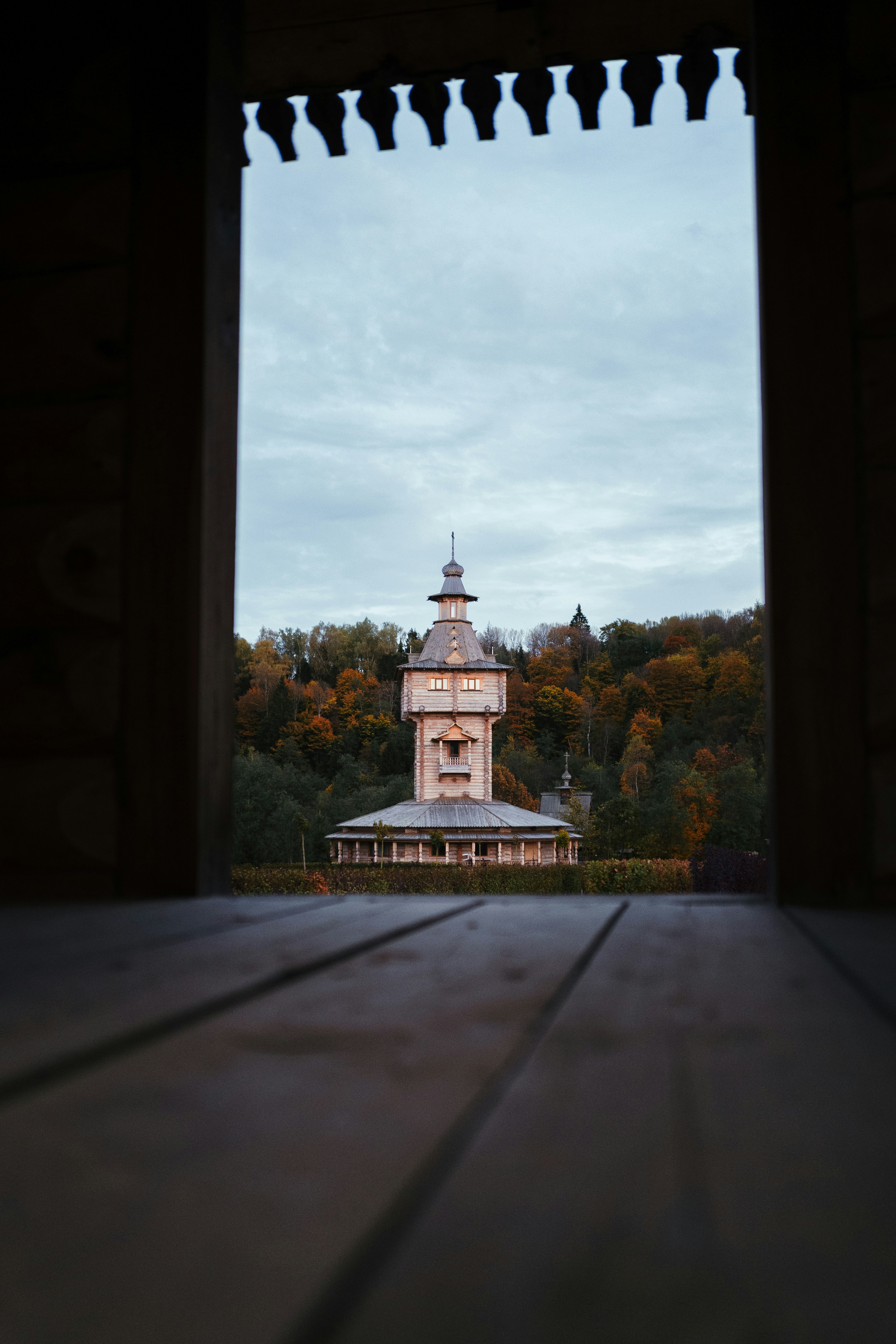 A view of a clock tower through an open door