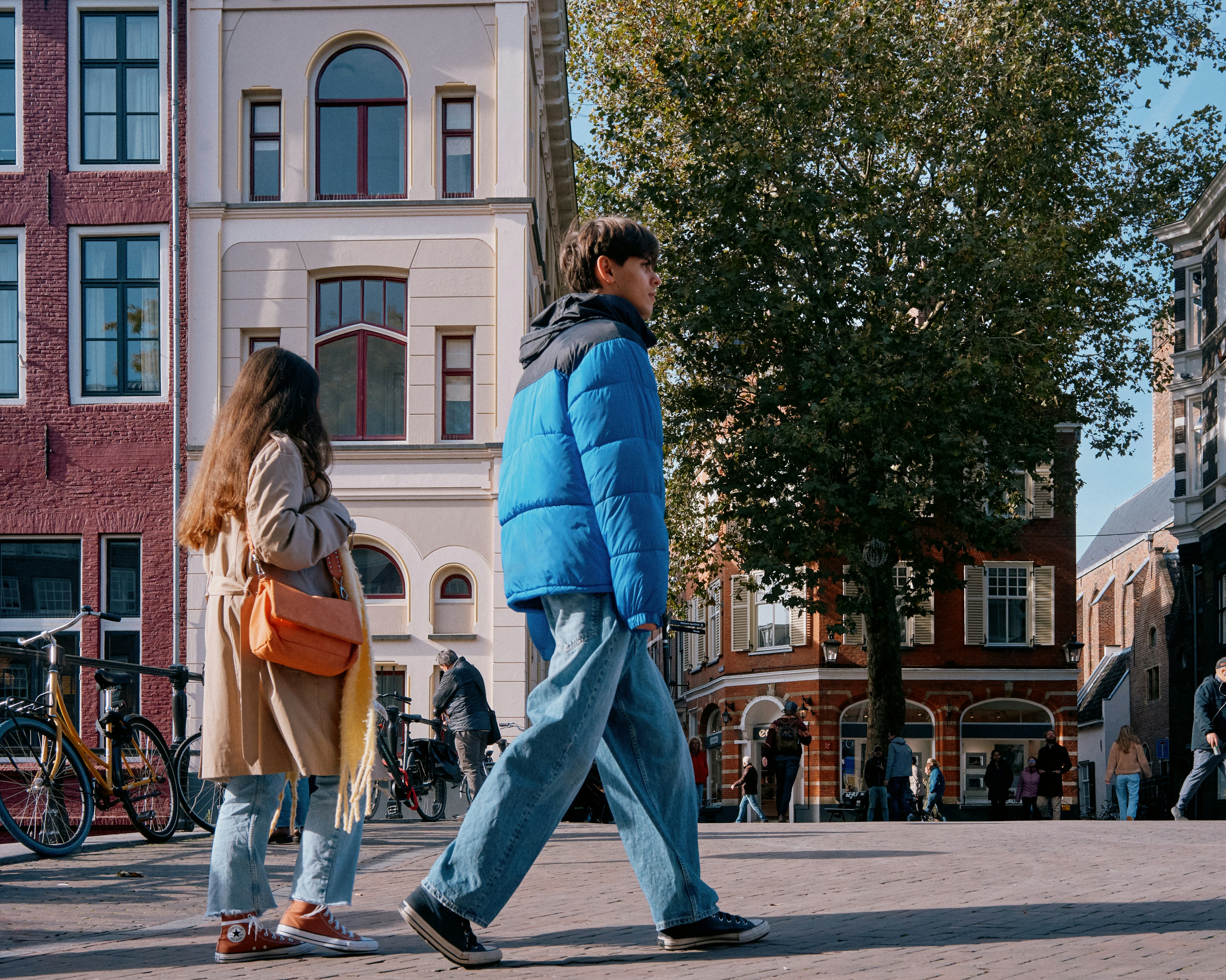 A man and a woman walking down a street