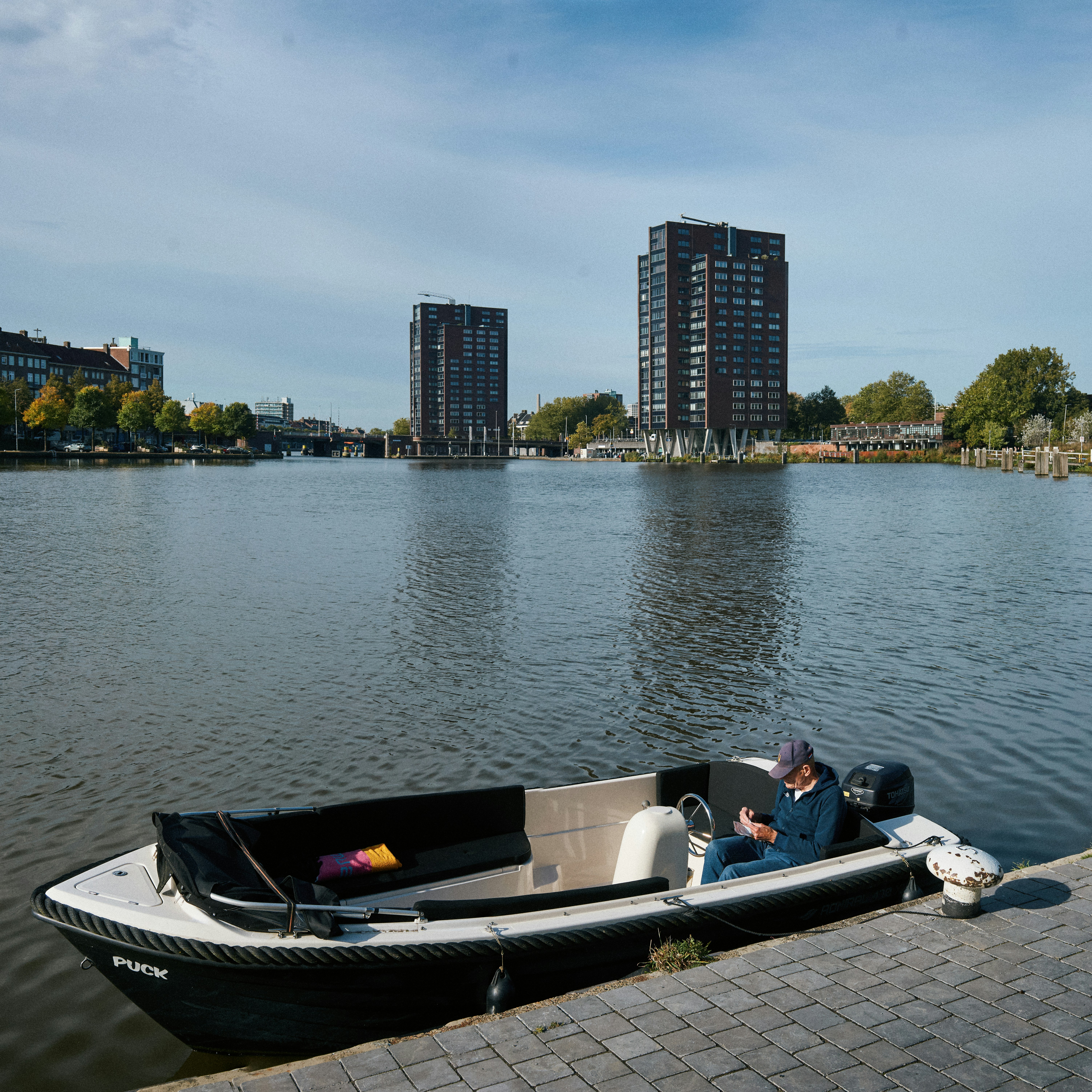 A man in a small boat on a body of water