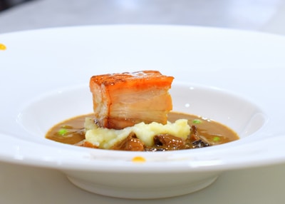 A white bowl filled with food on top of a table