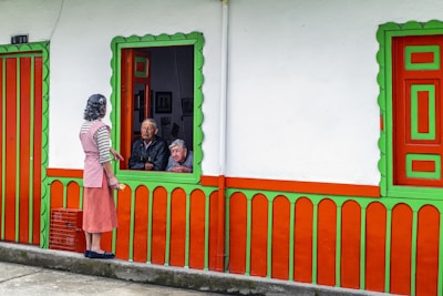 A woman standing outside of a colorful building