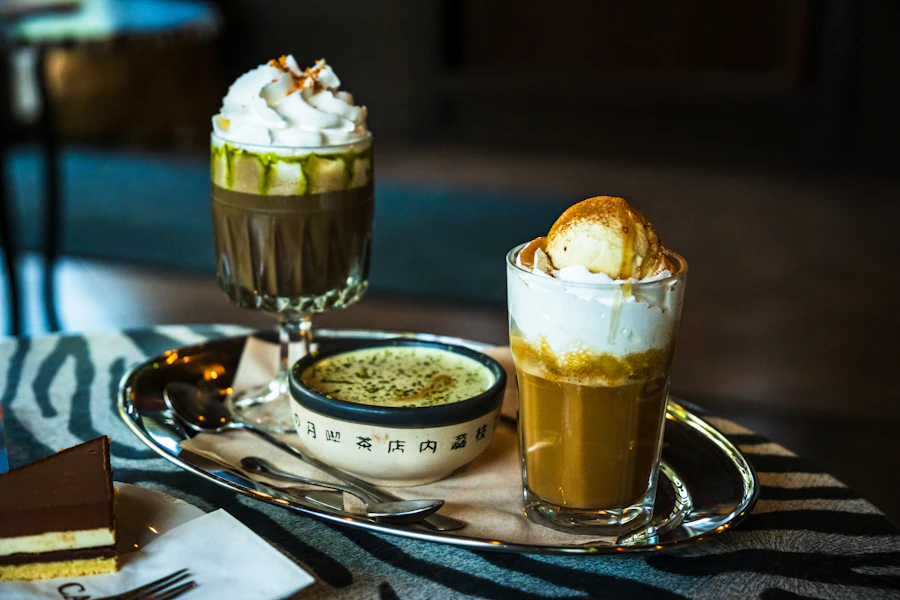 Coffee drinks topped with cream on a tray