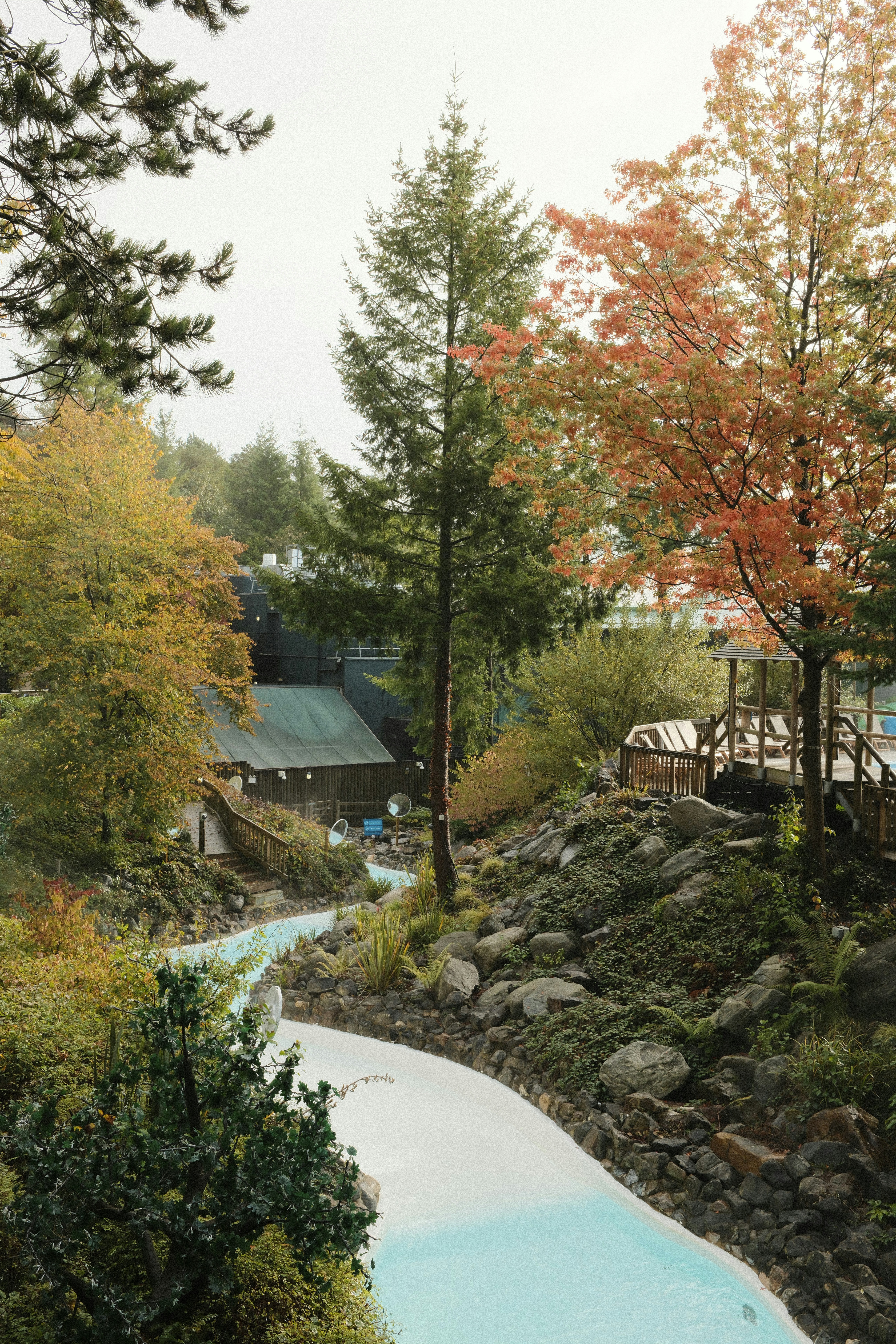 A water slide in a park surrounded by trees