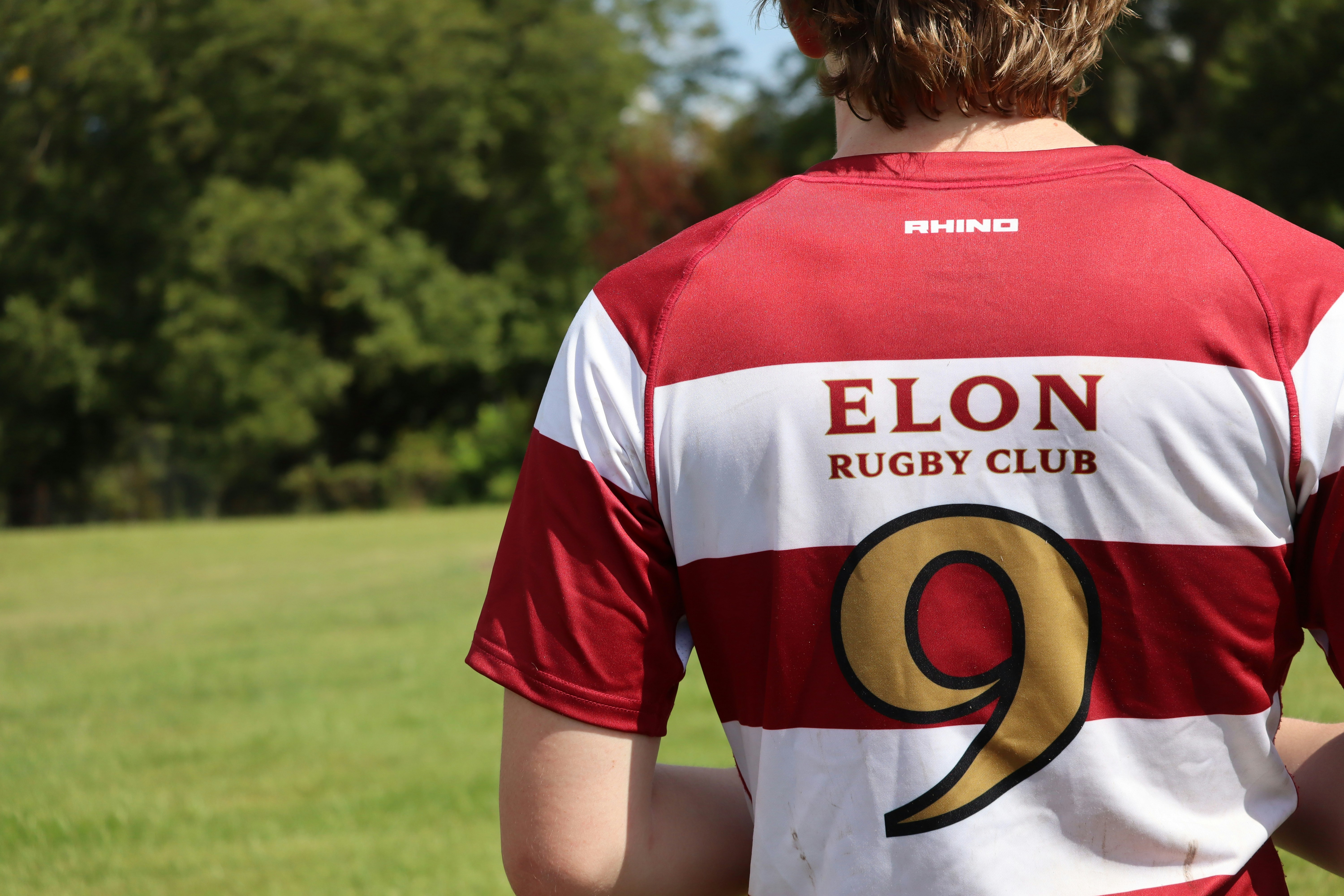 A man in a red and white jersey holding a frisbee