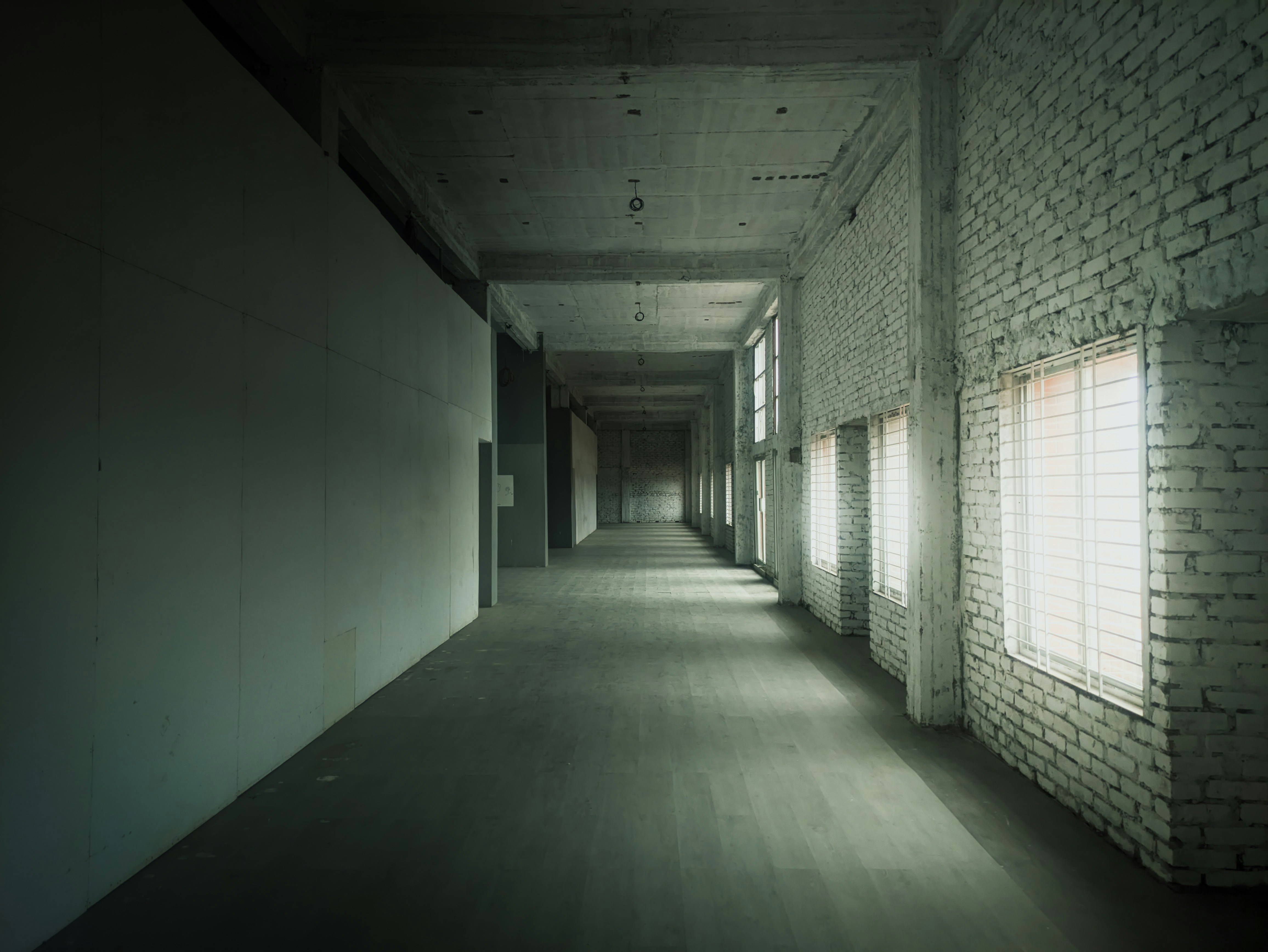 A long hallway with light coming through the windows