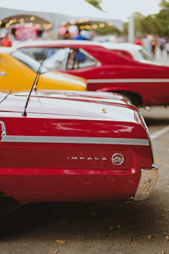 A row of classic cars parked next to each other
