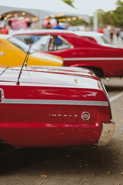 A row of classic cars parked next to each other