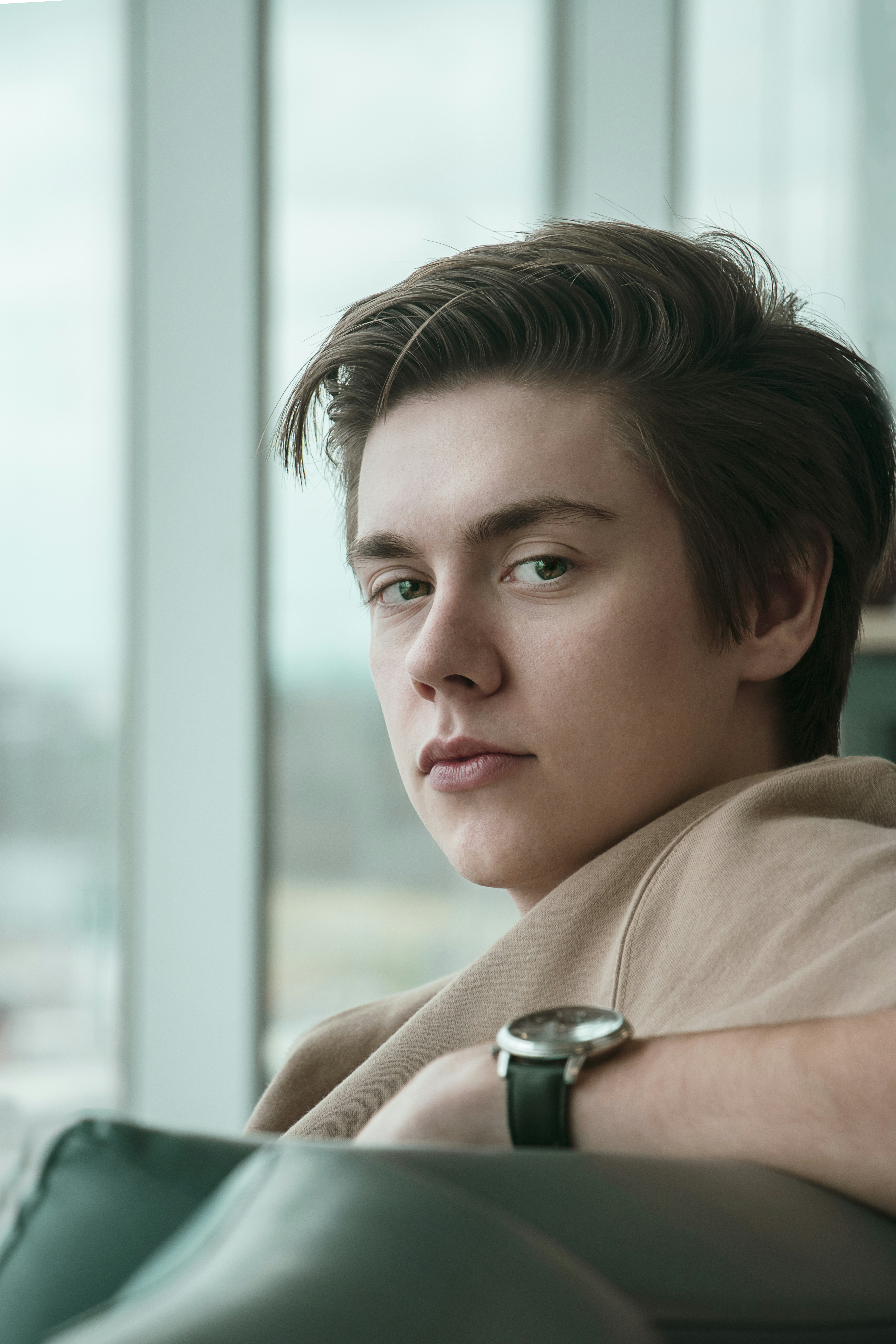 A man sitting on a couch with a watch on his arm