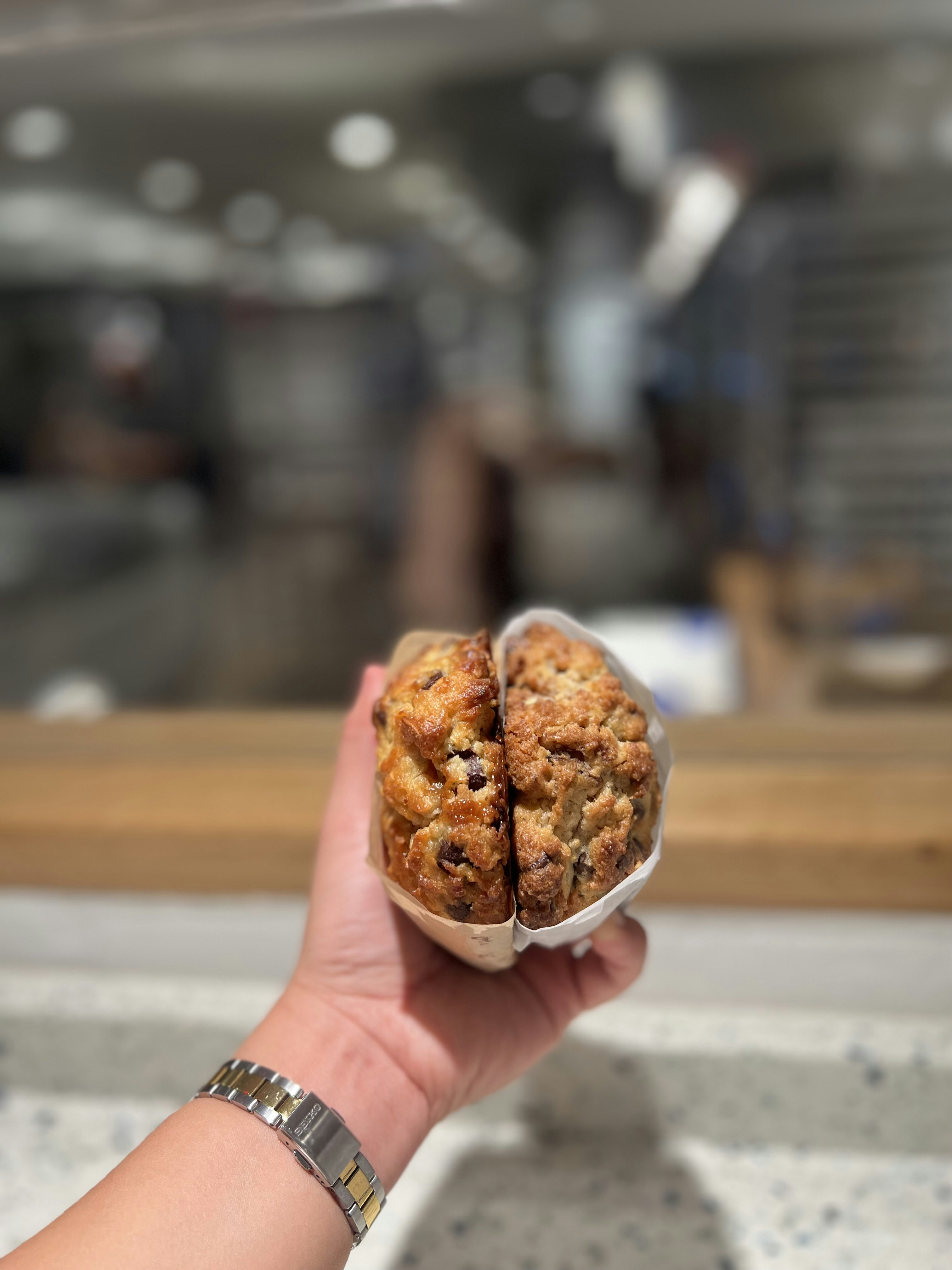 A person holding a pastry in their hand
