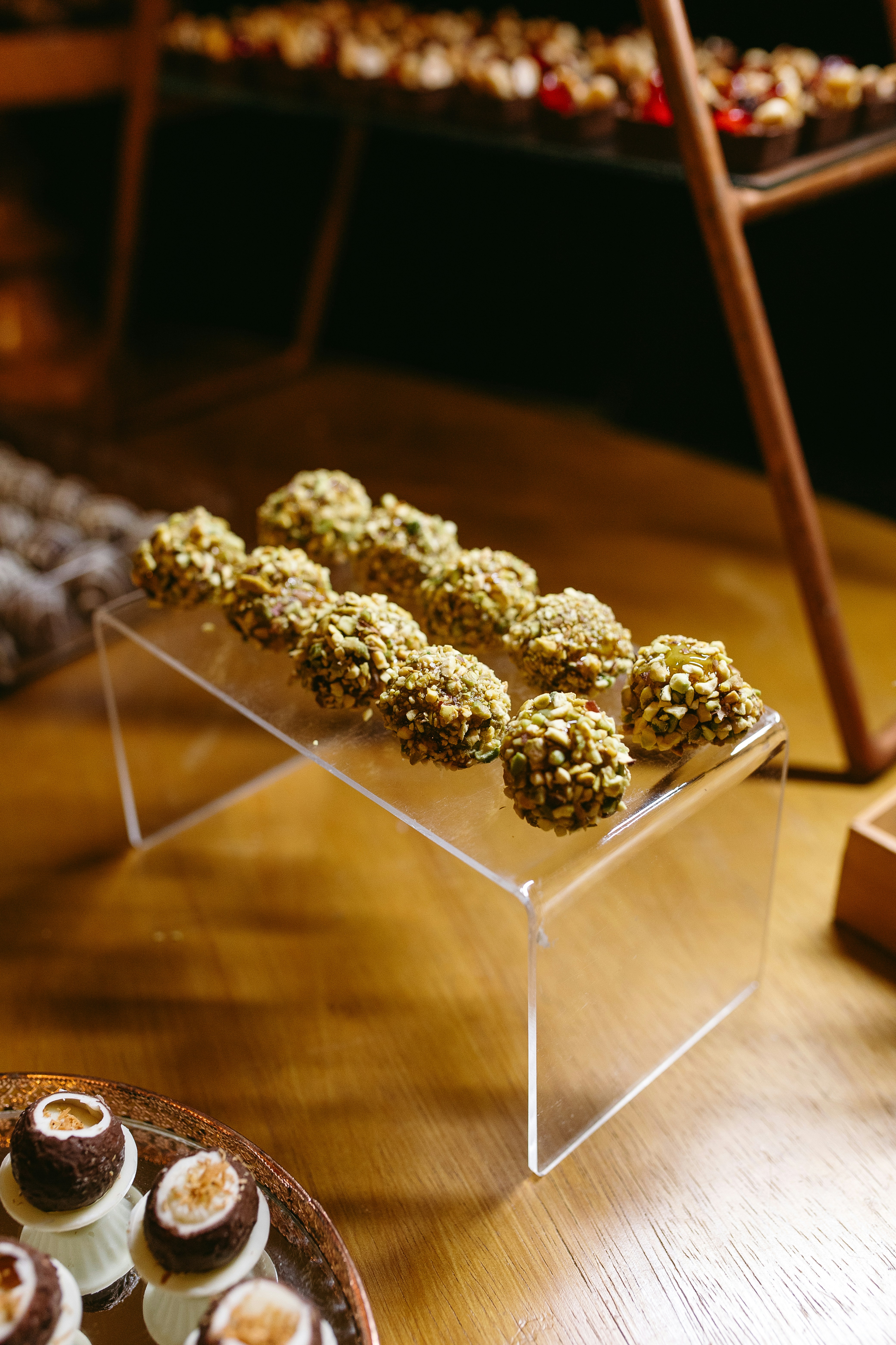 A wooden table topped with lots of desserts