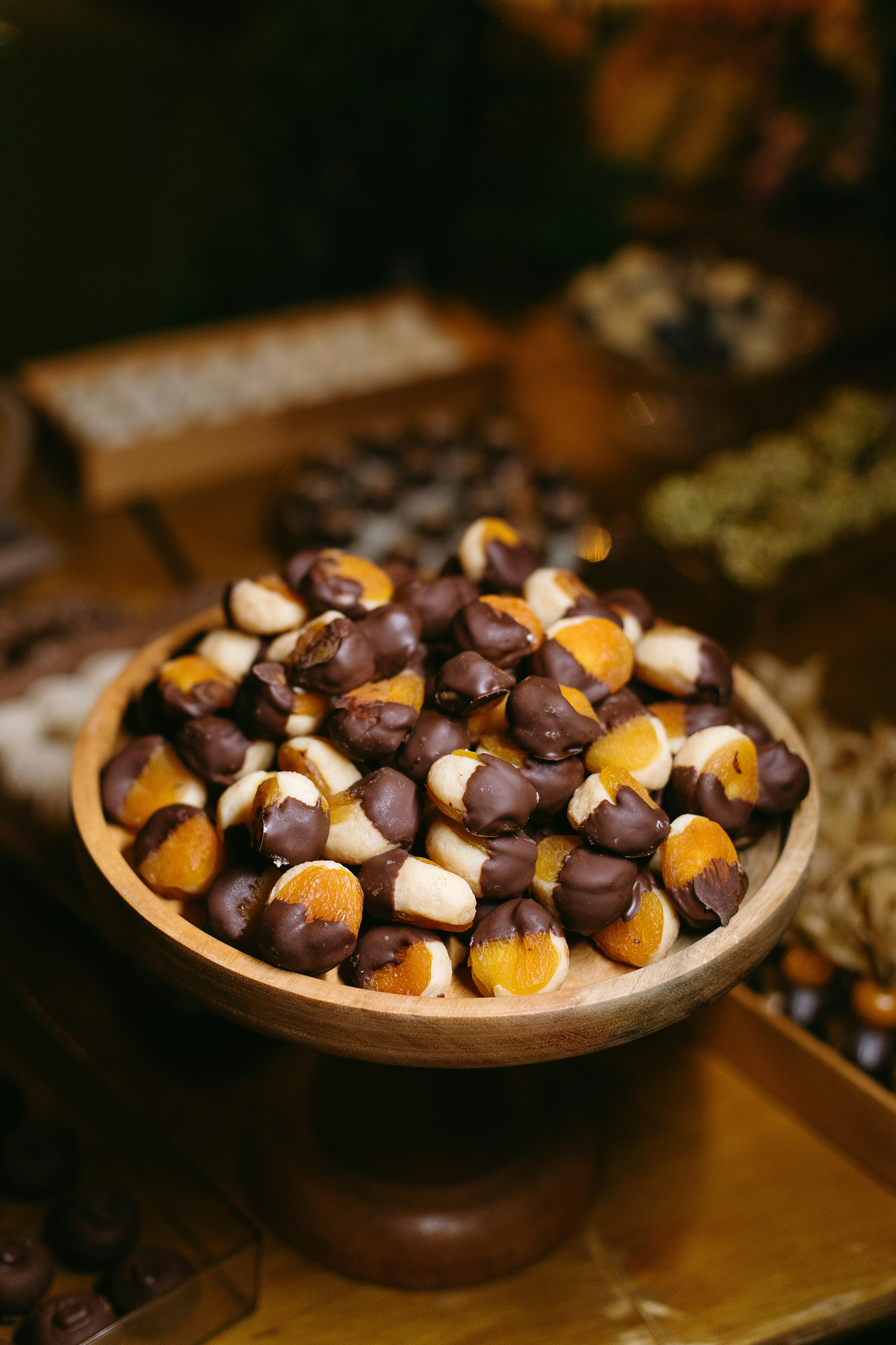 A wooden bowl filled with lots of candy