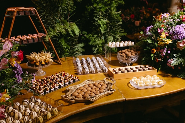 A wooden table topped with lots of desserts