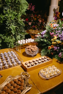 A wooden table topped with lots of desserts