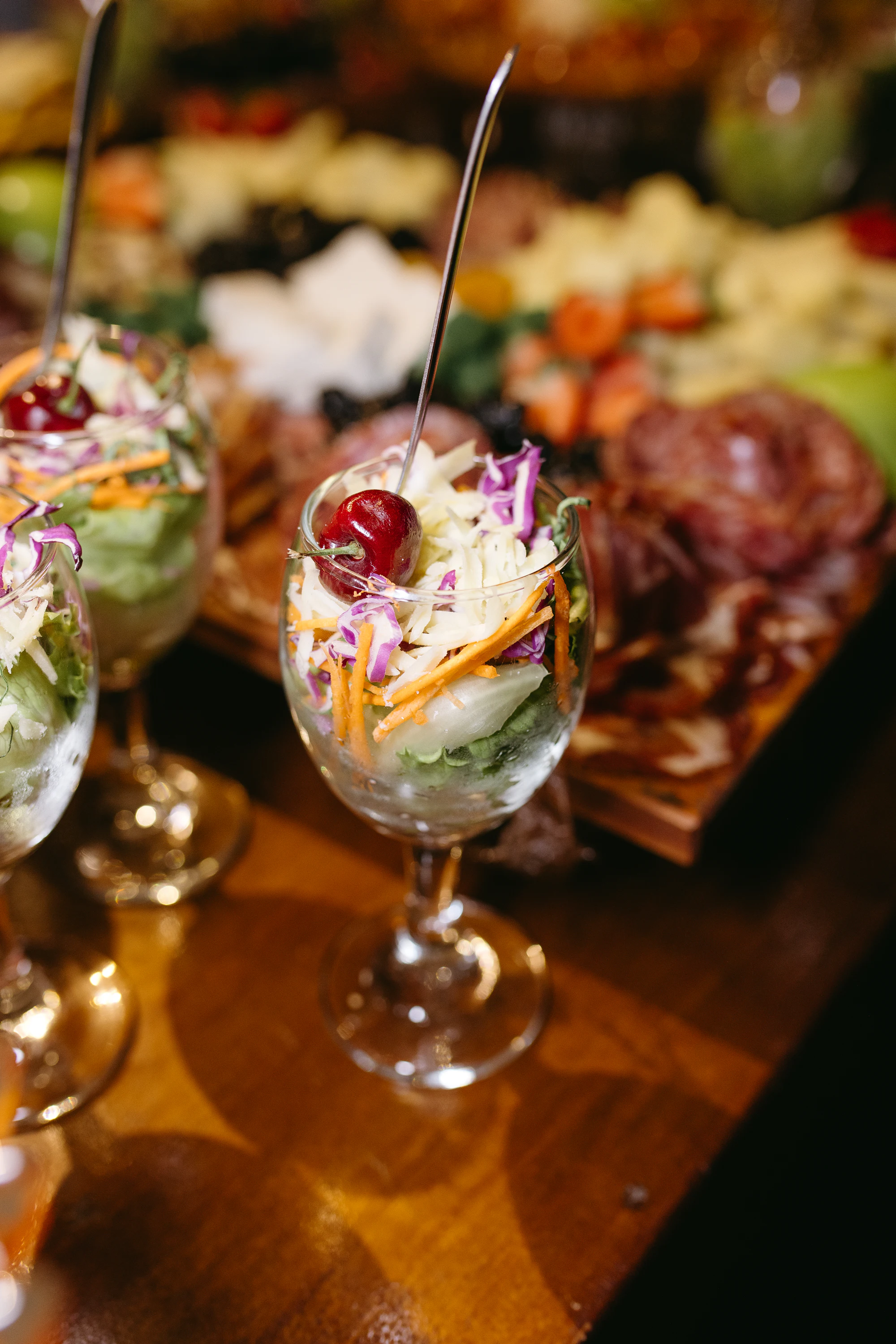 Rows of charcuterie cups lined up and ready to pass at a party