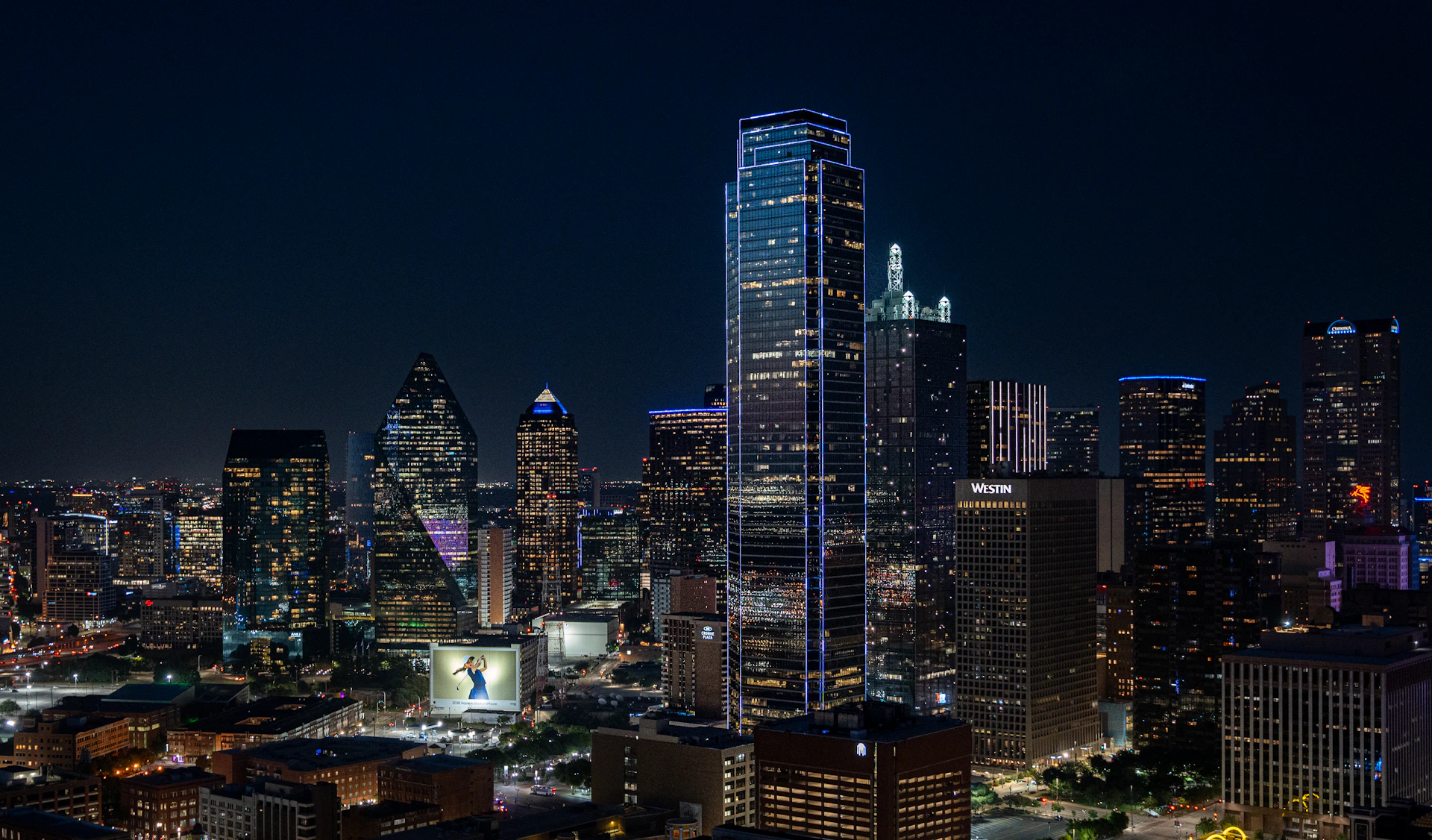 A view of a city at night from the top of a building