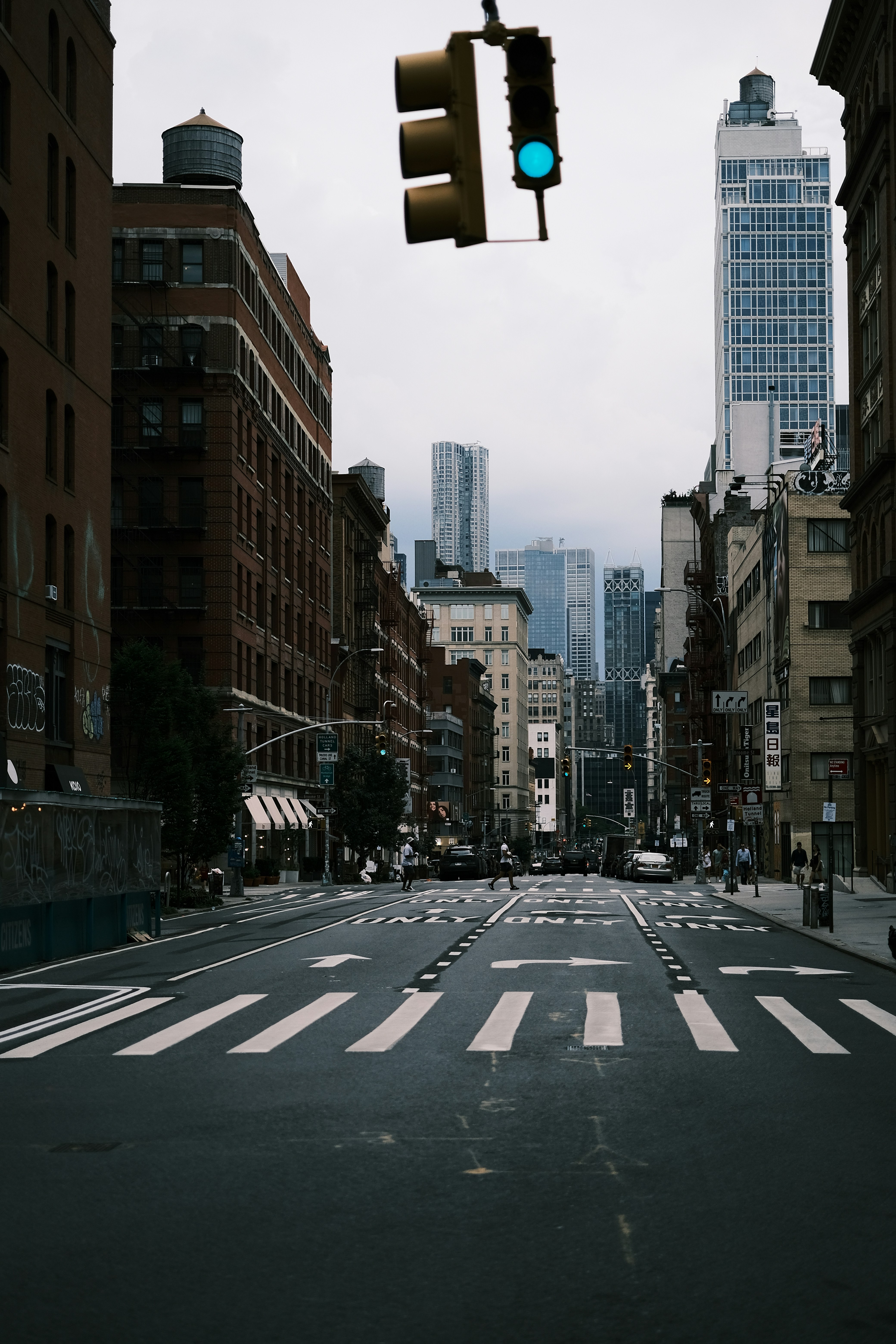 A green traffic light hanging over a city street