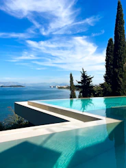 A large swimming pool with a view of the ocean