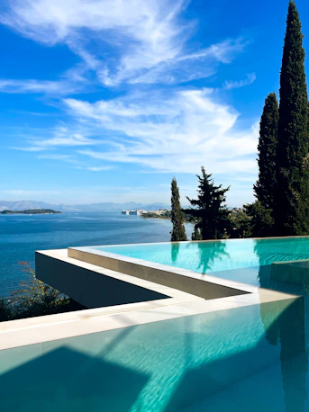 A large swimming pool with a view of the ocean