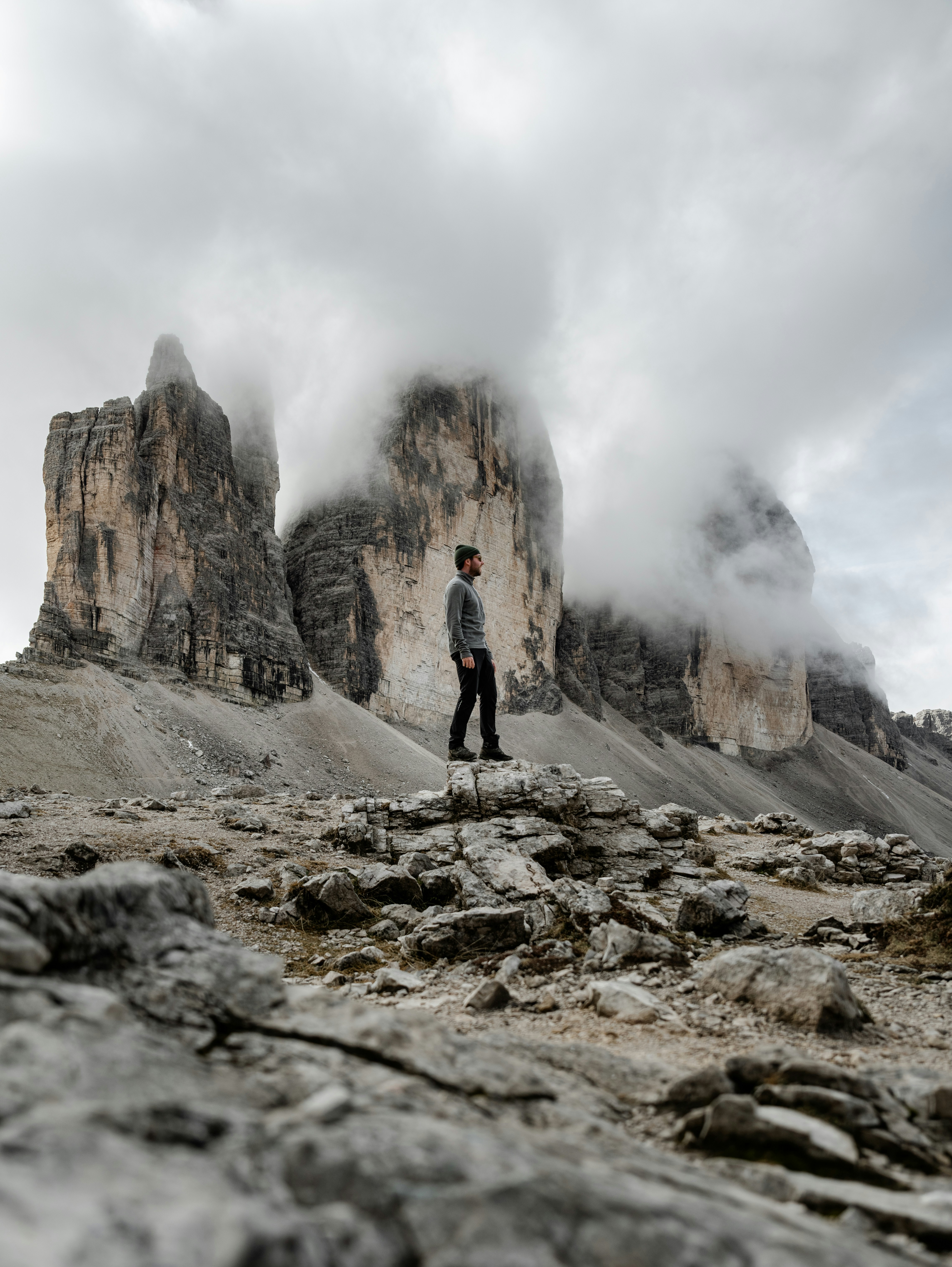 A man standing on top of a rocky mountain