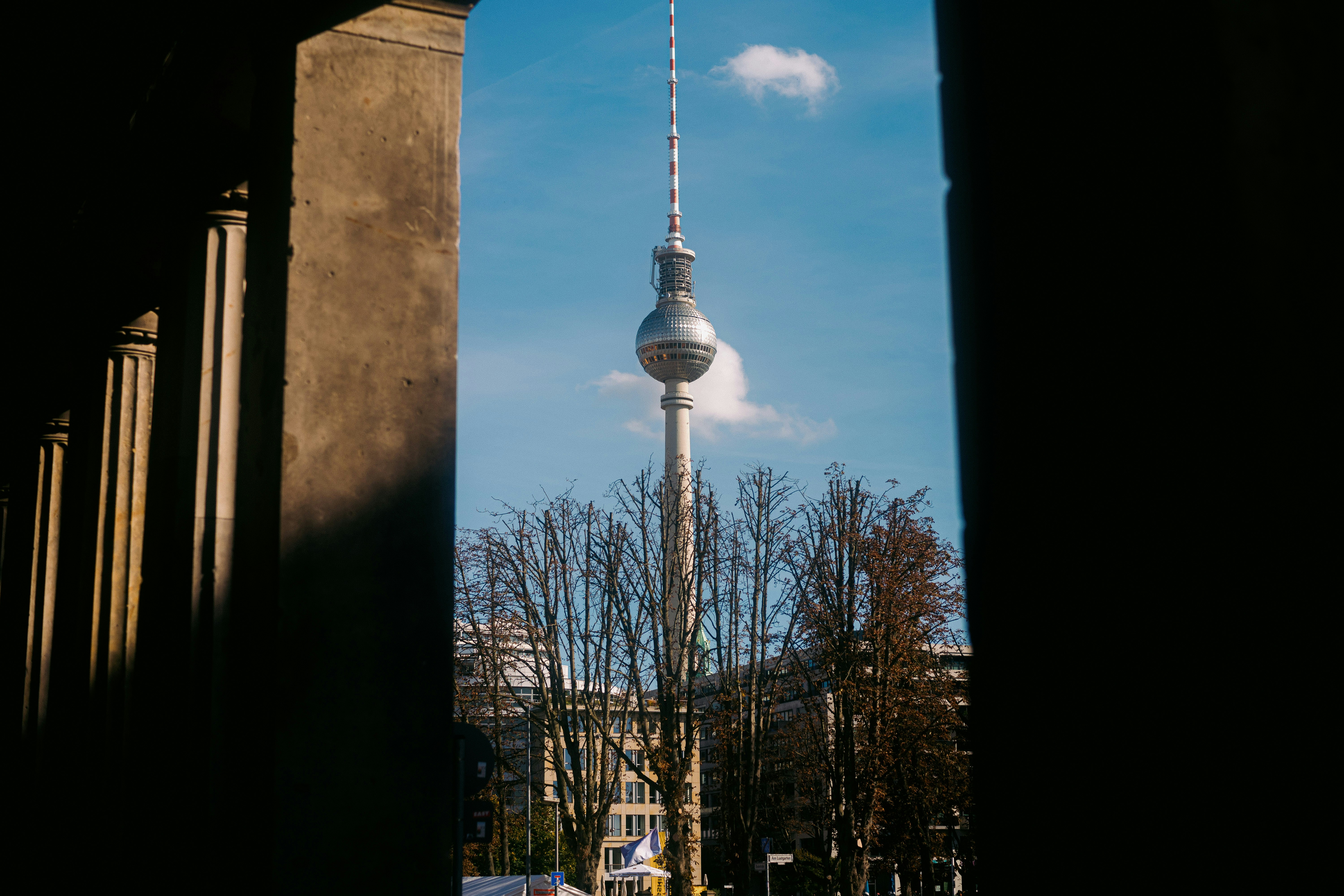 A tall tower towering over a city next to tall buildings