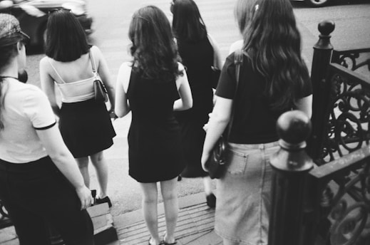 A group of women walking down a street