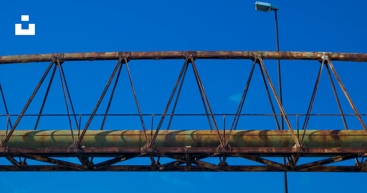 An old rusty bridge with a stop sign on it photo – Free Rust Image on ...