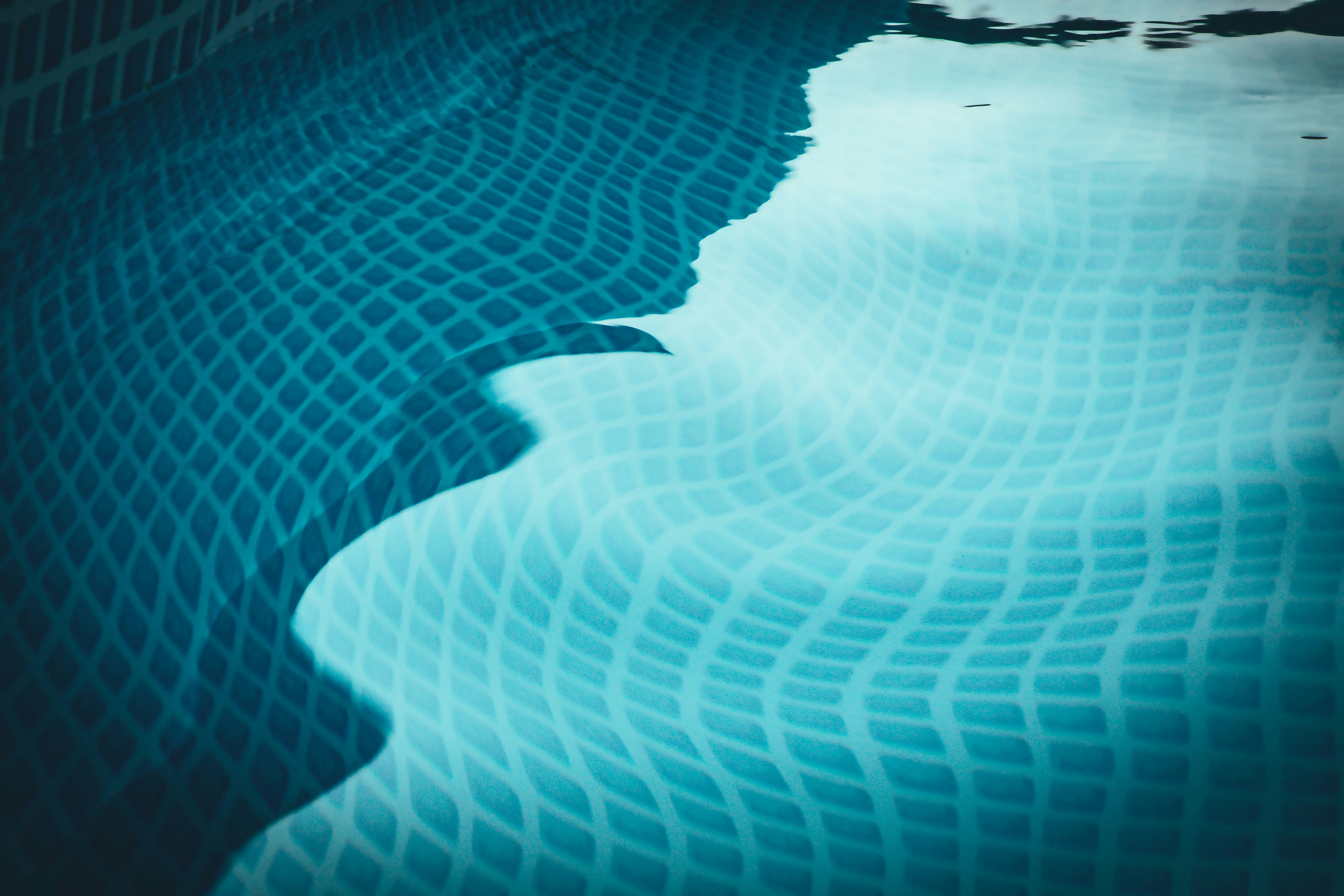 A pool with a reflection of the sky in it