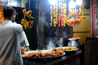 A man standing in front of a buffet filled with food