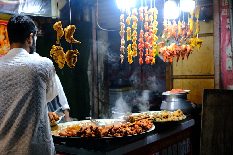 A man standing in front of a buffet filled with food