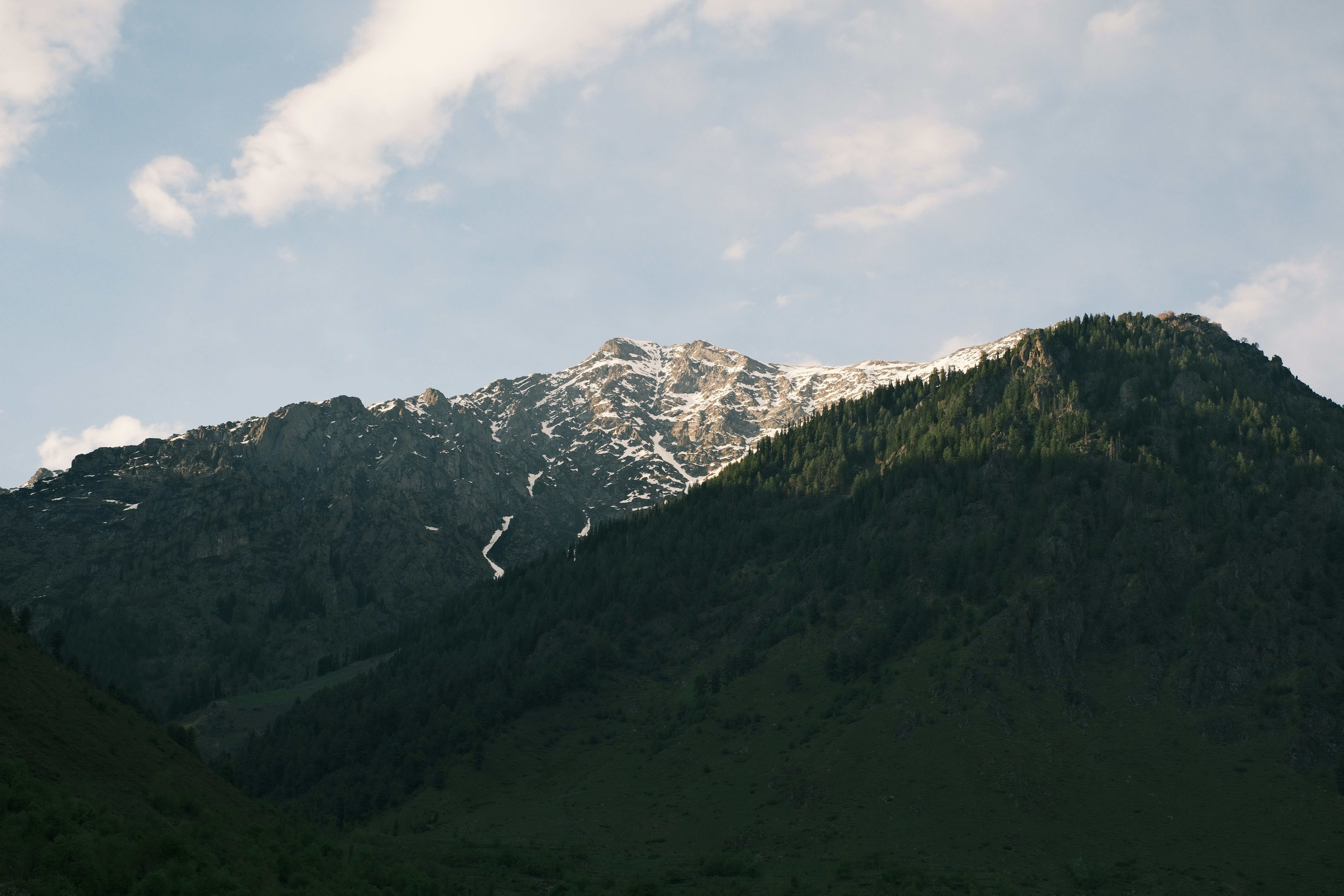 A view of a mountain with snow on the top