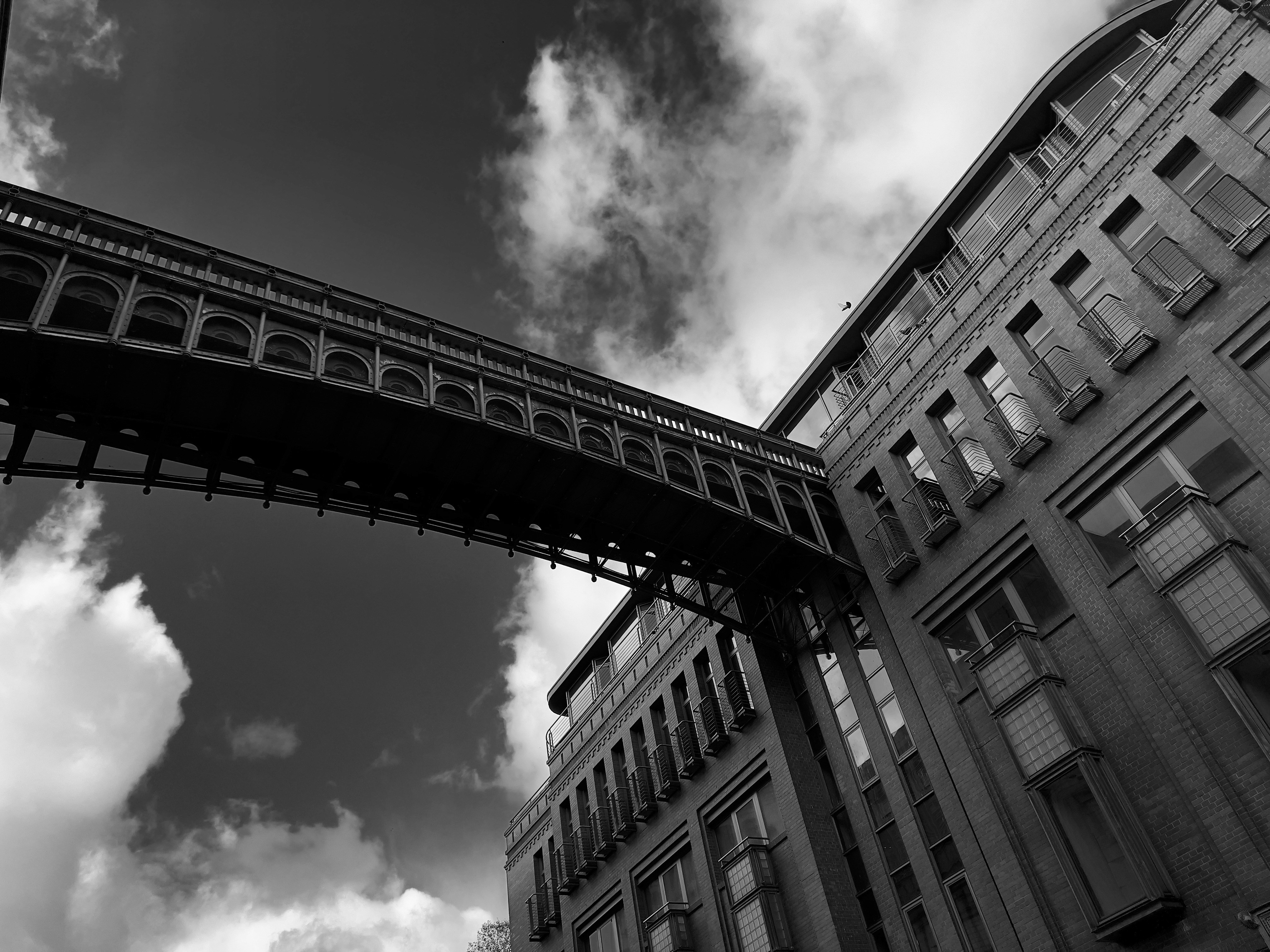 A black and white photo of a bridge and buildings