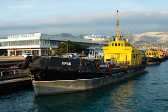 A yellow and black boat is in the water