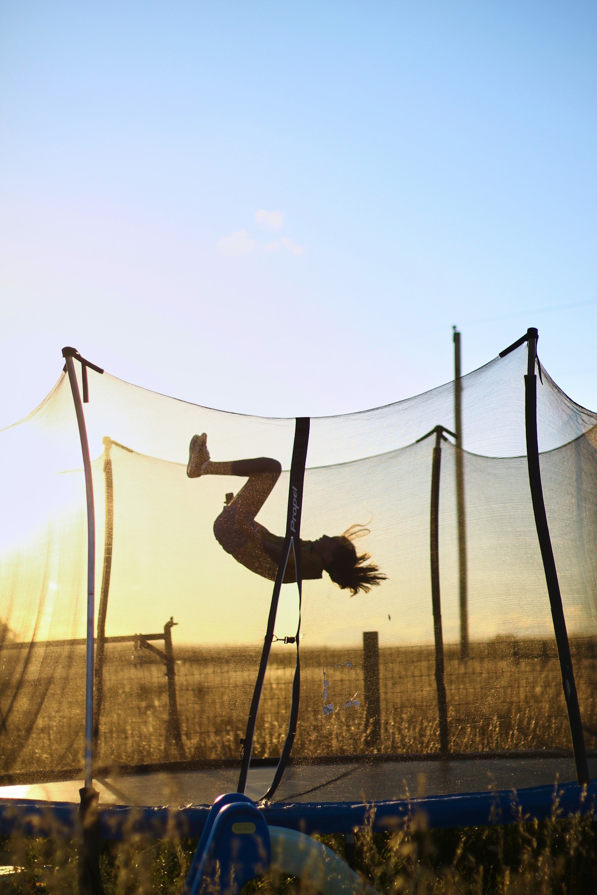 A person is doing a trick on a trampoline