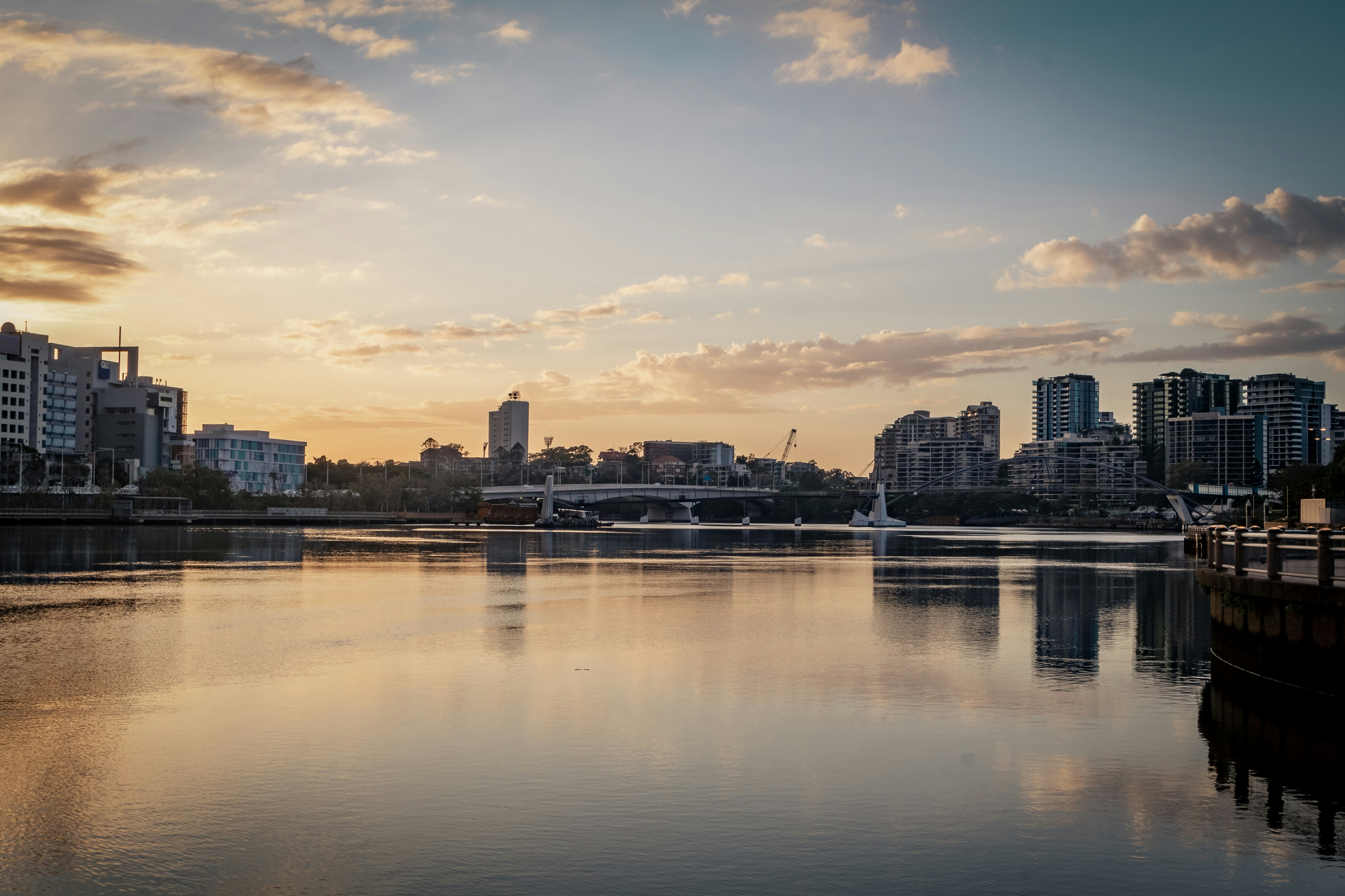 A body of water with a city in the background