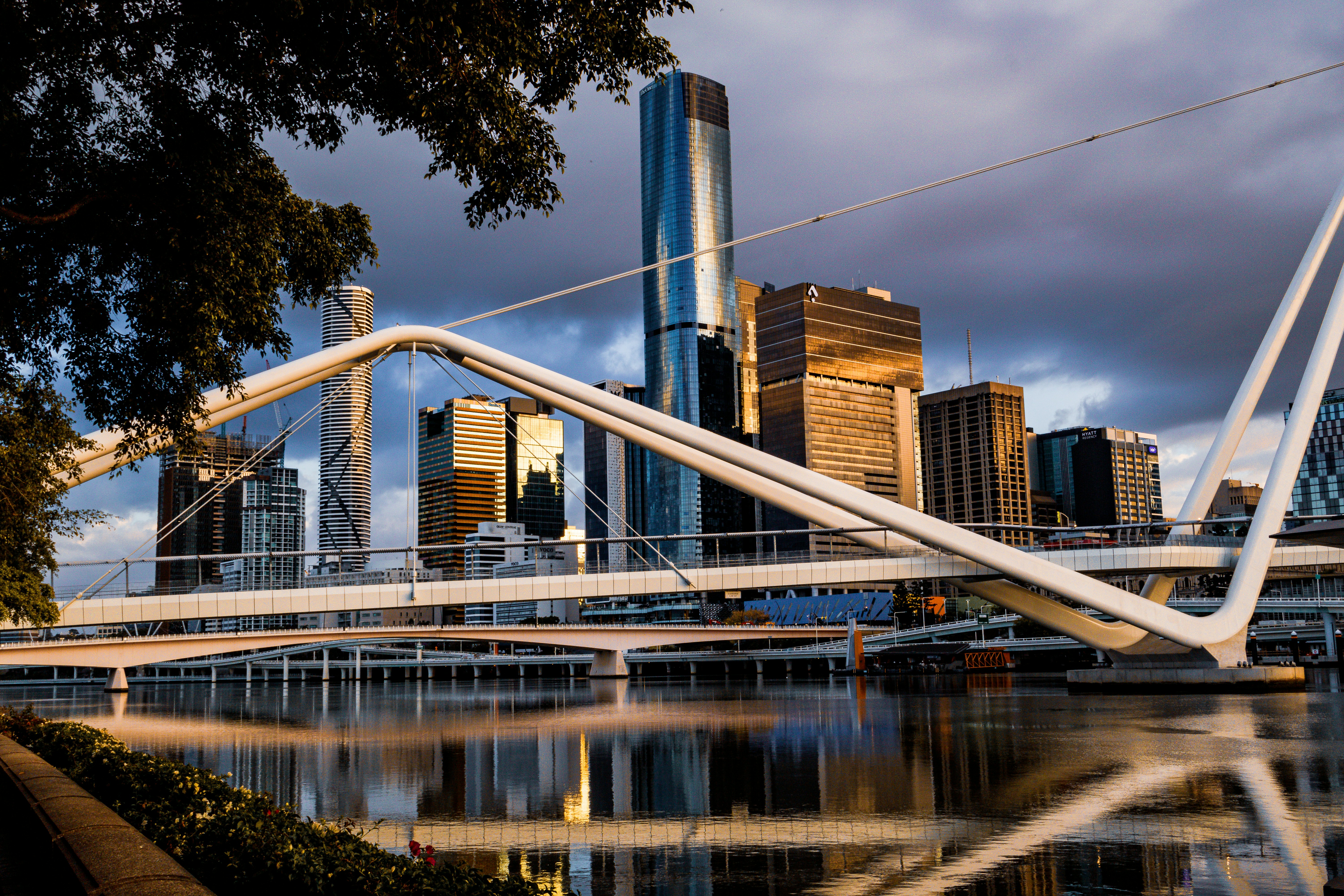 A bridge over a body of water with a city in the background