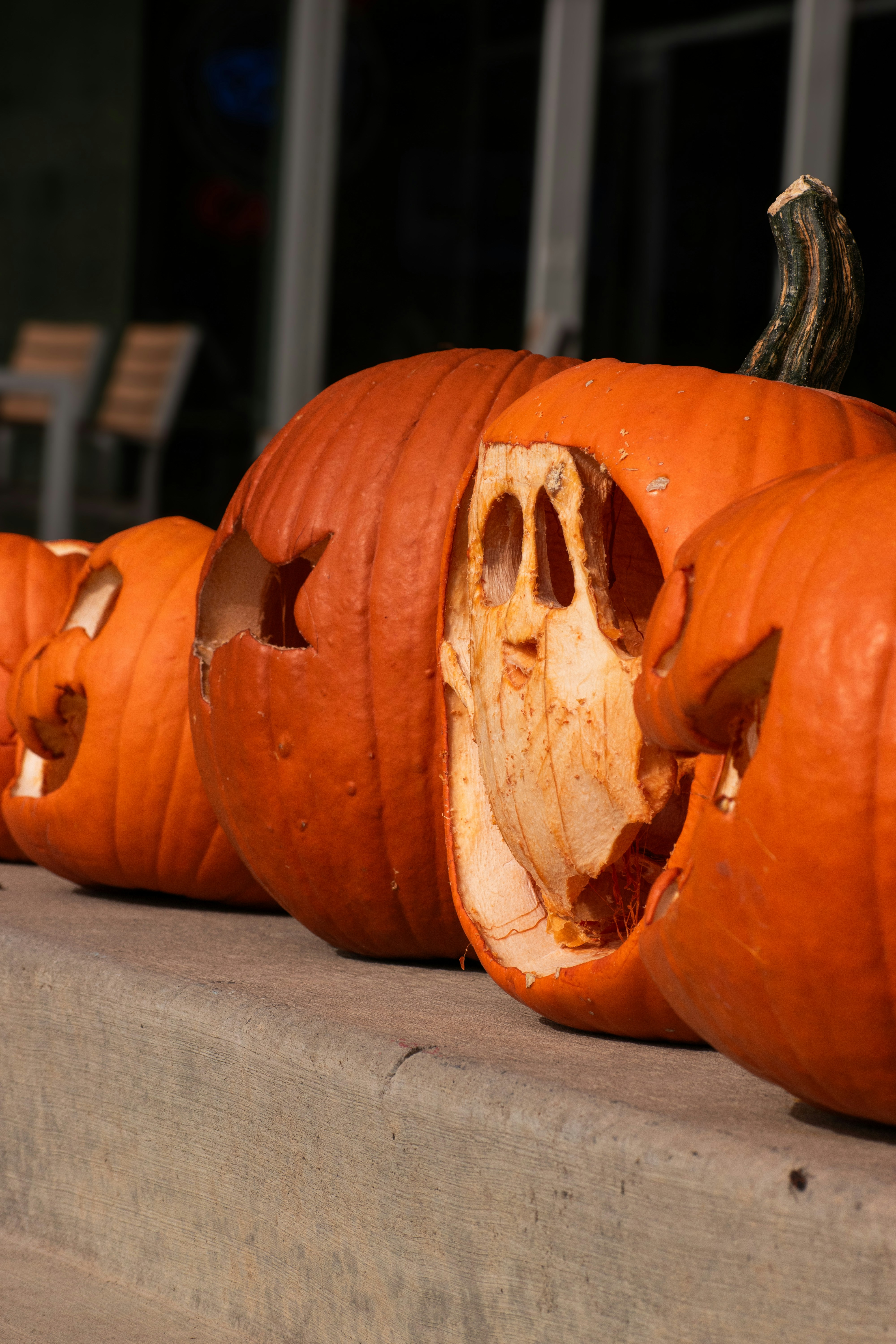 A group of carved pumpkins sitting on a step