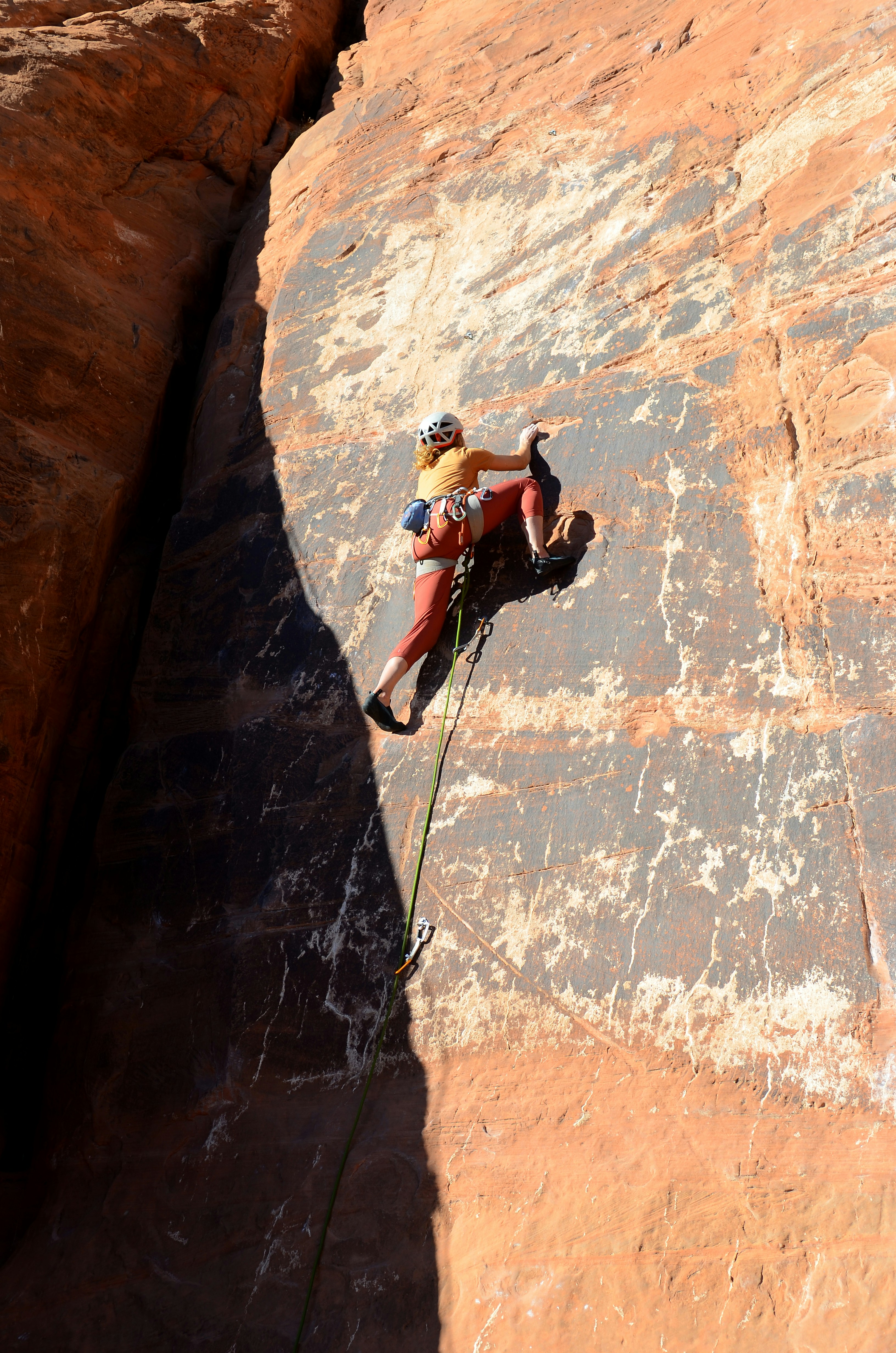 A man climbing up the side of a cliff