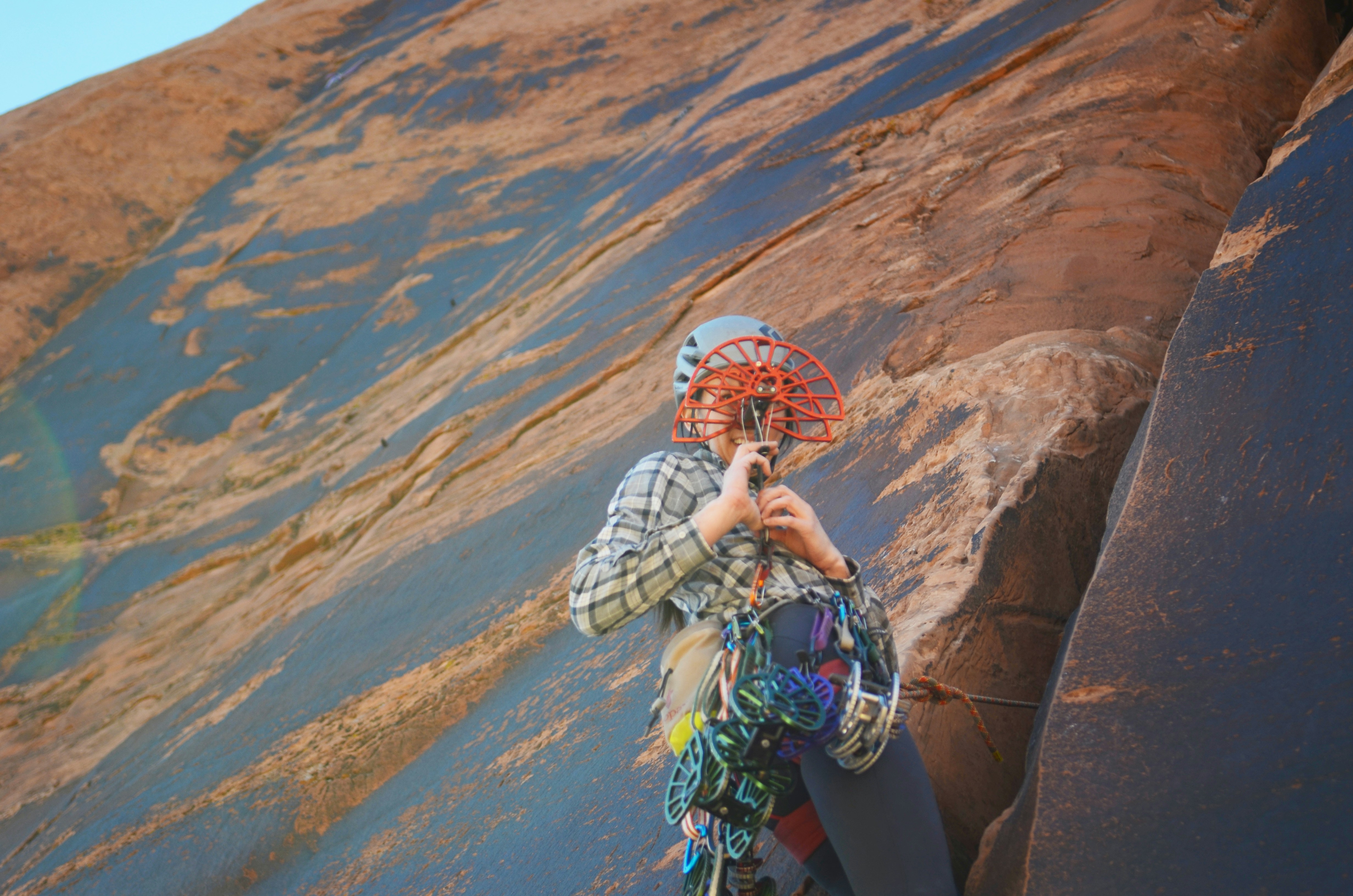 A woman standing on top of a rock next to a mountain